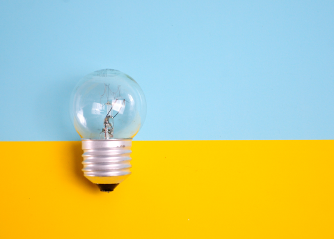 Image of a light bulb on a blue and yellow background