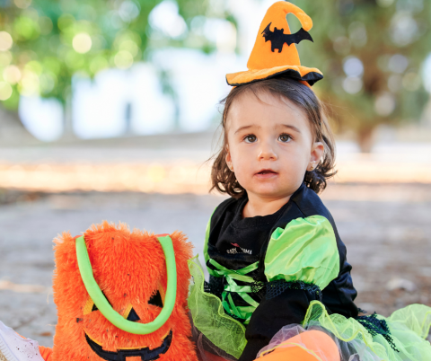 Toddler with a trick or treat basket